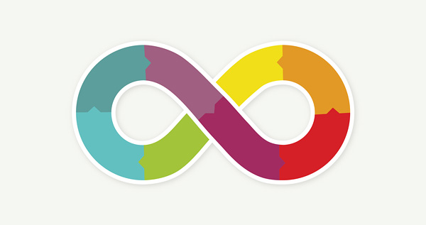 A colourful illustration on a light grey background of an infinity sign stroked in white and filled with colours of the rainbow.