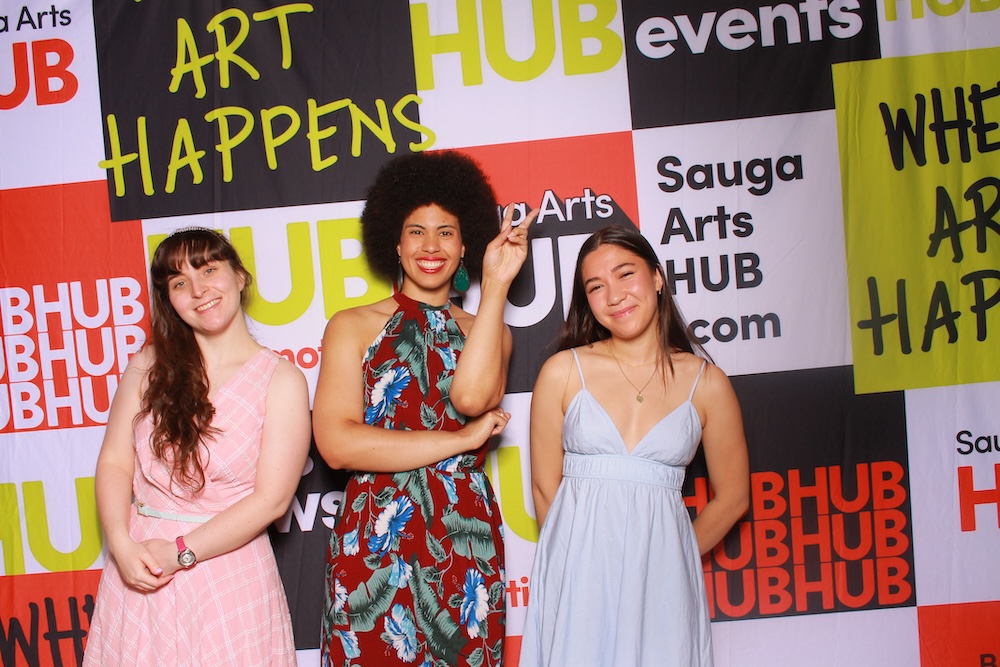 A large crowd watches dancers perform at night in an outdoor amphitheatre.